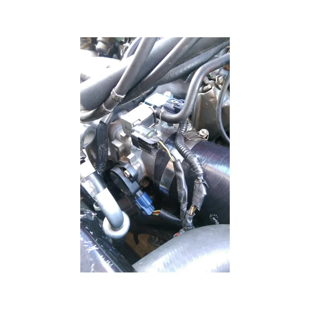 Sensor installed on the throttle body in an engine bay